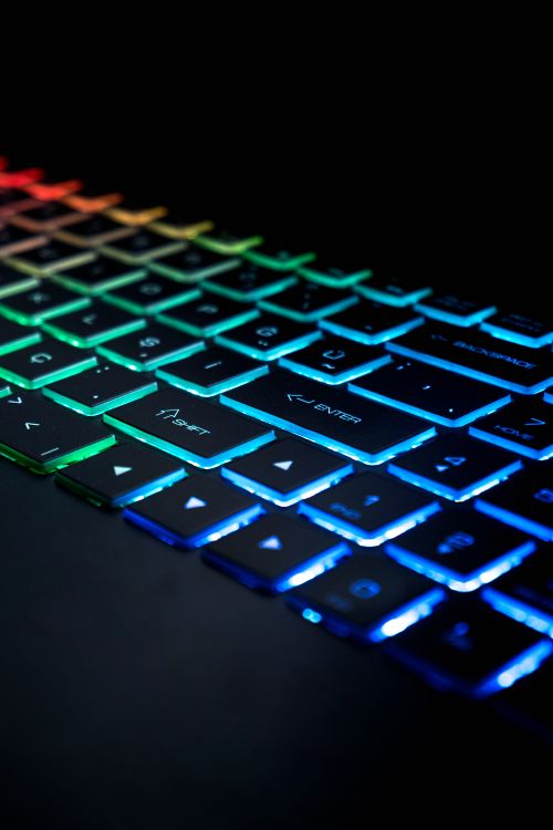 Free Close-up of a colorful illuminated RGB keyboard with vibrant lights. Stock Photo