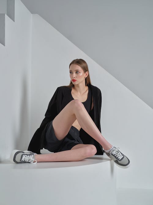 Free Model in a Black Jacket Over a Sports Bra and Shorts Stock Photo
