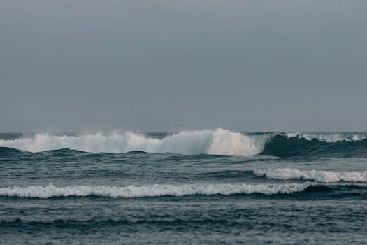 Tranquil view of ocean waves crashing on the shore in Malang, East Java.