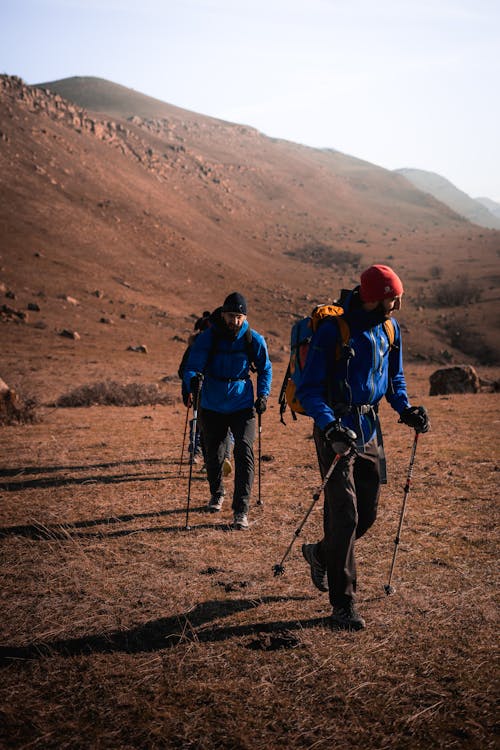 Man Hiking on Arid Grassland