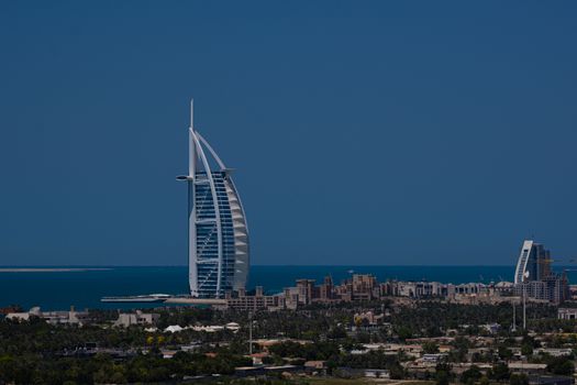 A breathtaking view of the Burj Al Arab, a symbol of modern architecture, set against the Dubai skyline.