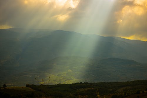 Free View of the Sun Shining on Mountains  Stock Photo