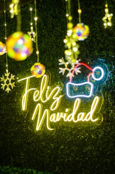 Neon sign with 'Feliz Navidad' glowing among Christmas baubles and ornaments.