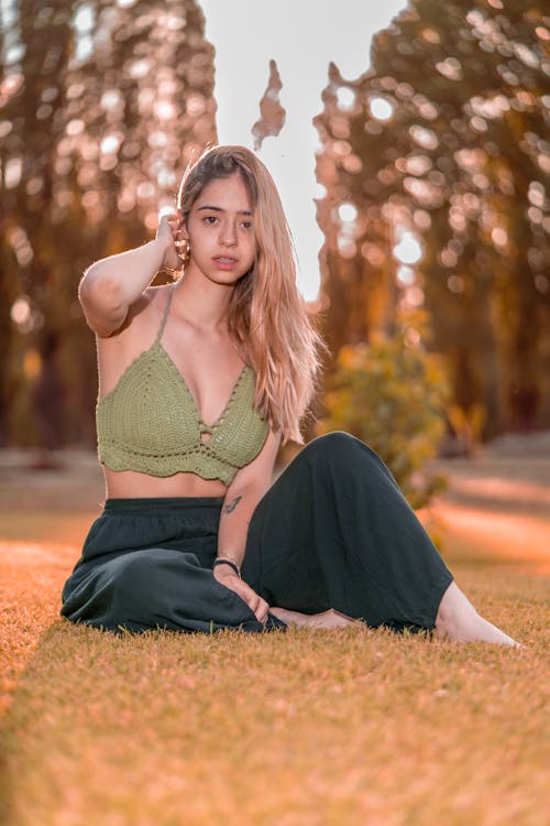 Free Barefoot Woman Sitting on Grass in Rural Landscape Stock Photo