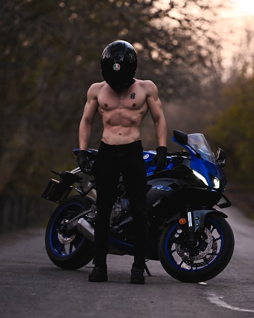 Muscled Shirtless Biker Standing Next to His Motorcycle