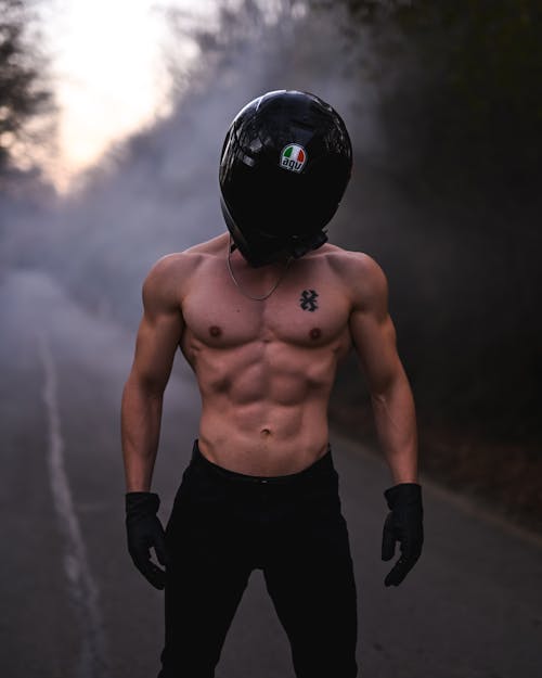 Brawny Shirtless Motorcyclist Standing on a Country Road