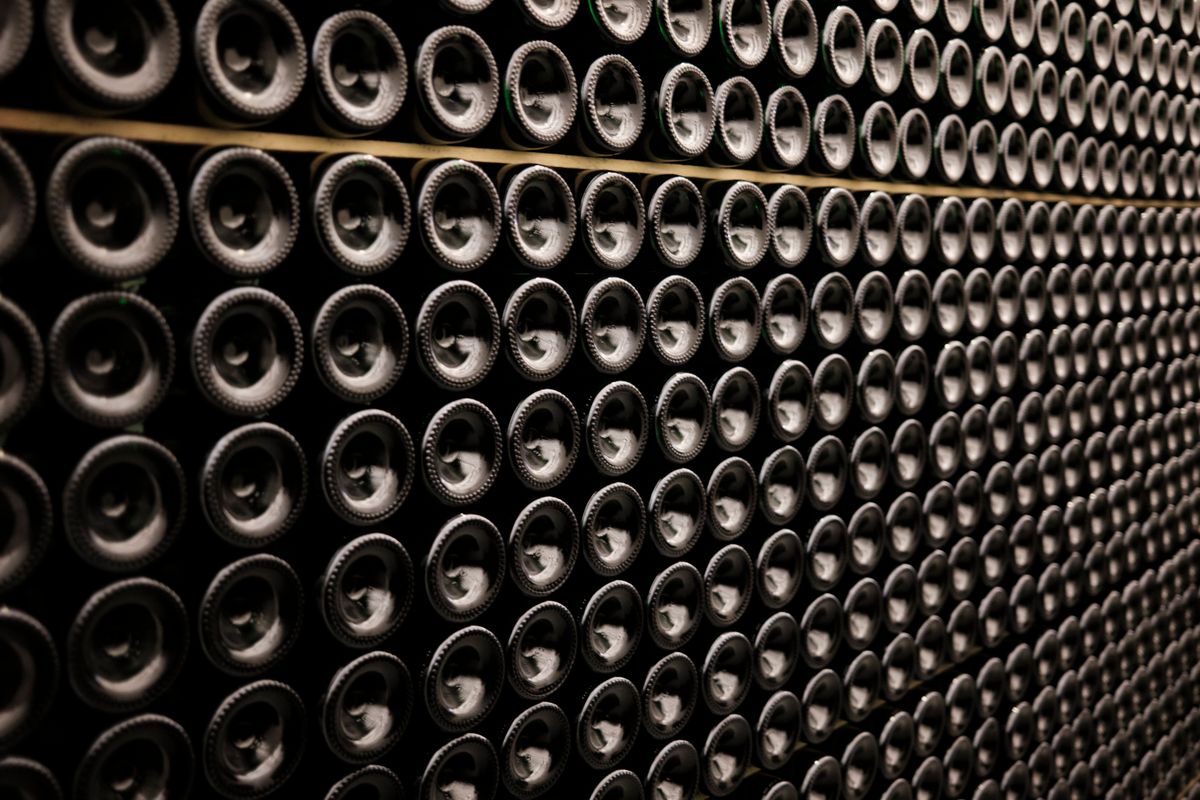Close view of wine bottles stored in orderly rows in a cellar