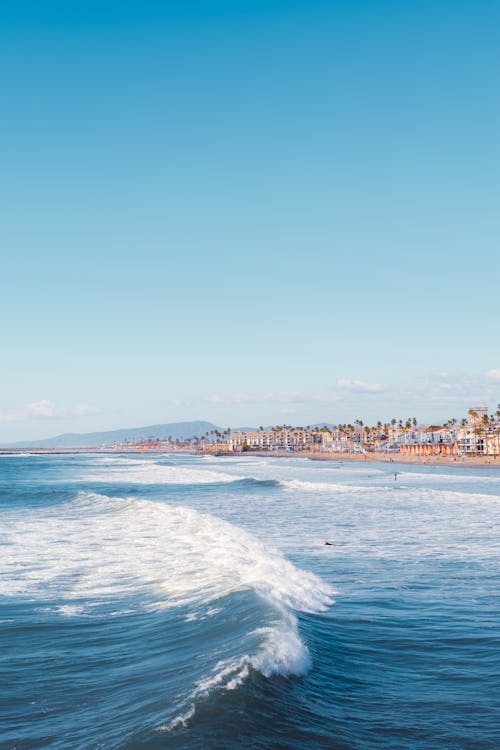 Rough Sea and a City on the Coast 