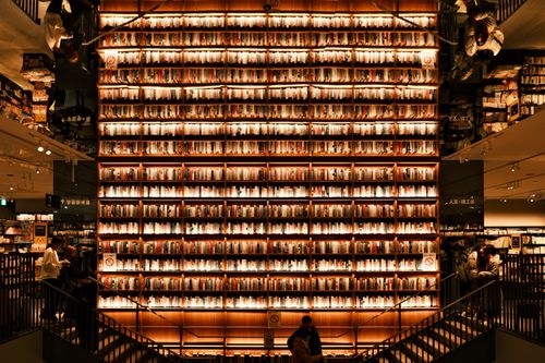 Free Bookshelf display with warm lighting in Nagoya, Japan bookstore interior. Stock Photo