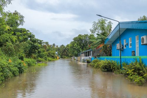 Free A tropical street in Nolhivaranfaru, Maldives, submerged due to flooding. Stock Photo