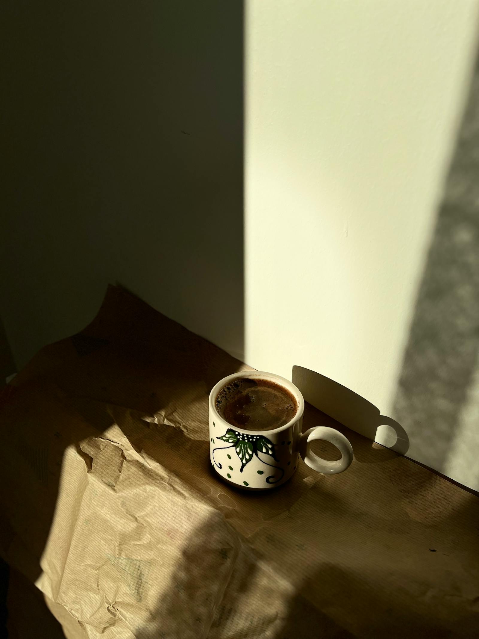 Coffee mug in sunlight on a wooden surface at home