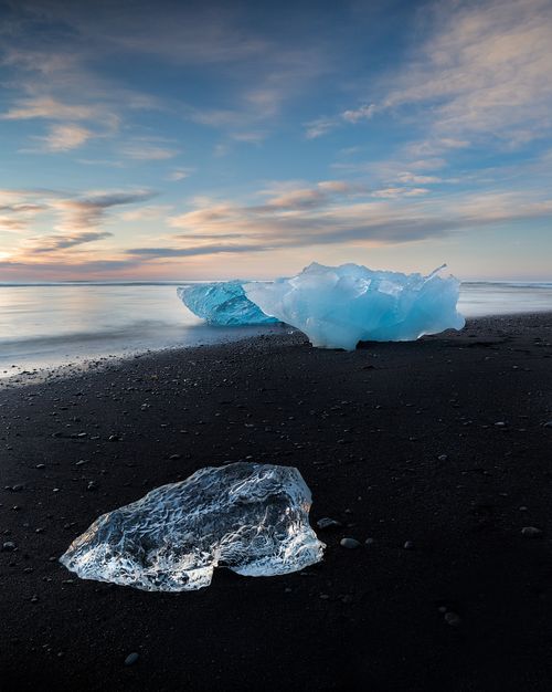 Free Stunning view of icebergs on a black sand beach in Iceland at dawn, capturing the beauty of winter. Stock Photo