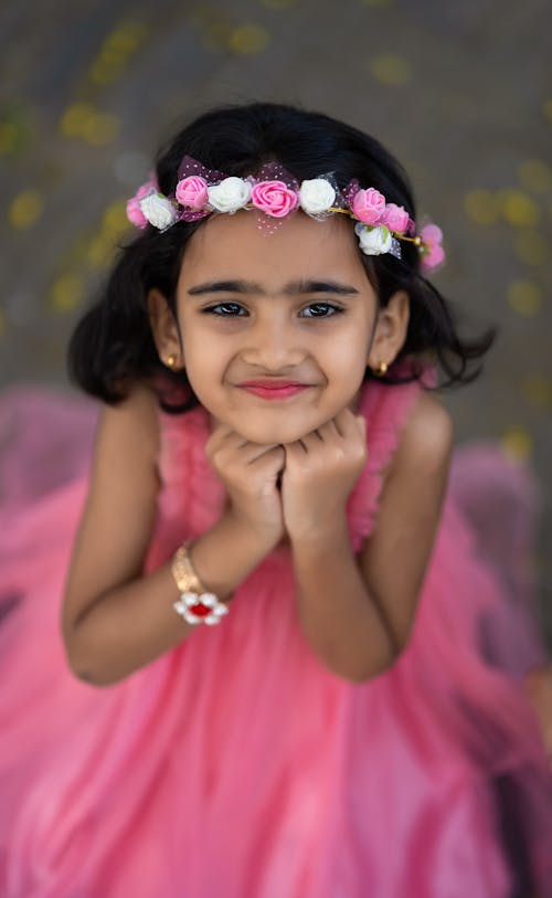 Portrait of a Little Girl in a Pink Dress and a Flower Crown 