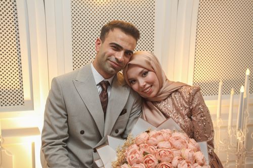 Free A heartwarming portrait of a happy couple in elegant attire, capturing their special moment indoors. Stock Photo