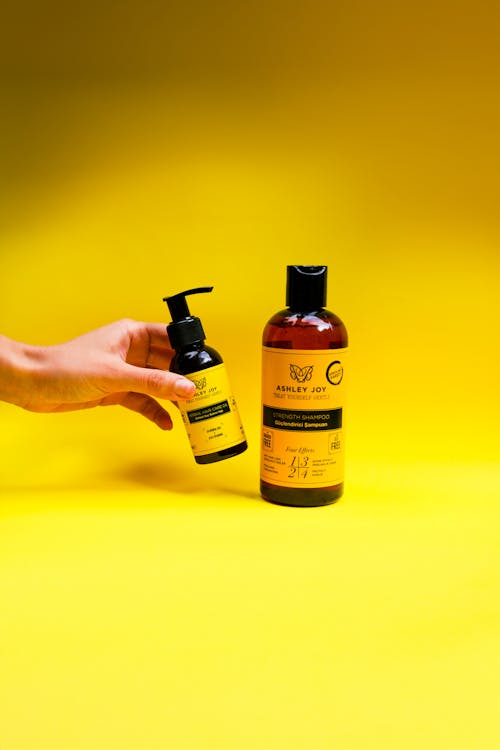 Close up of Two Bottles on a Yellow Background