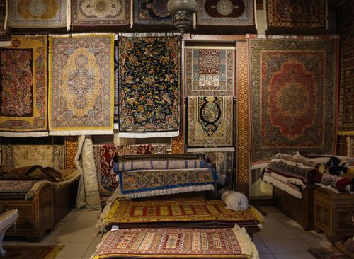 Free A captivating display of intricately designed traditional rugs in a cozy shop. Stock Photo