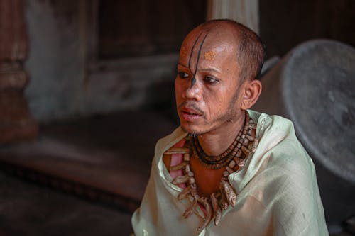 Man With a Face Tattoo and Necklace