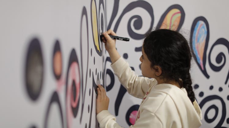 Girl Drawing On Wall