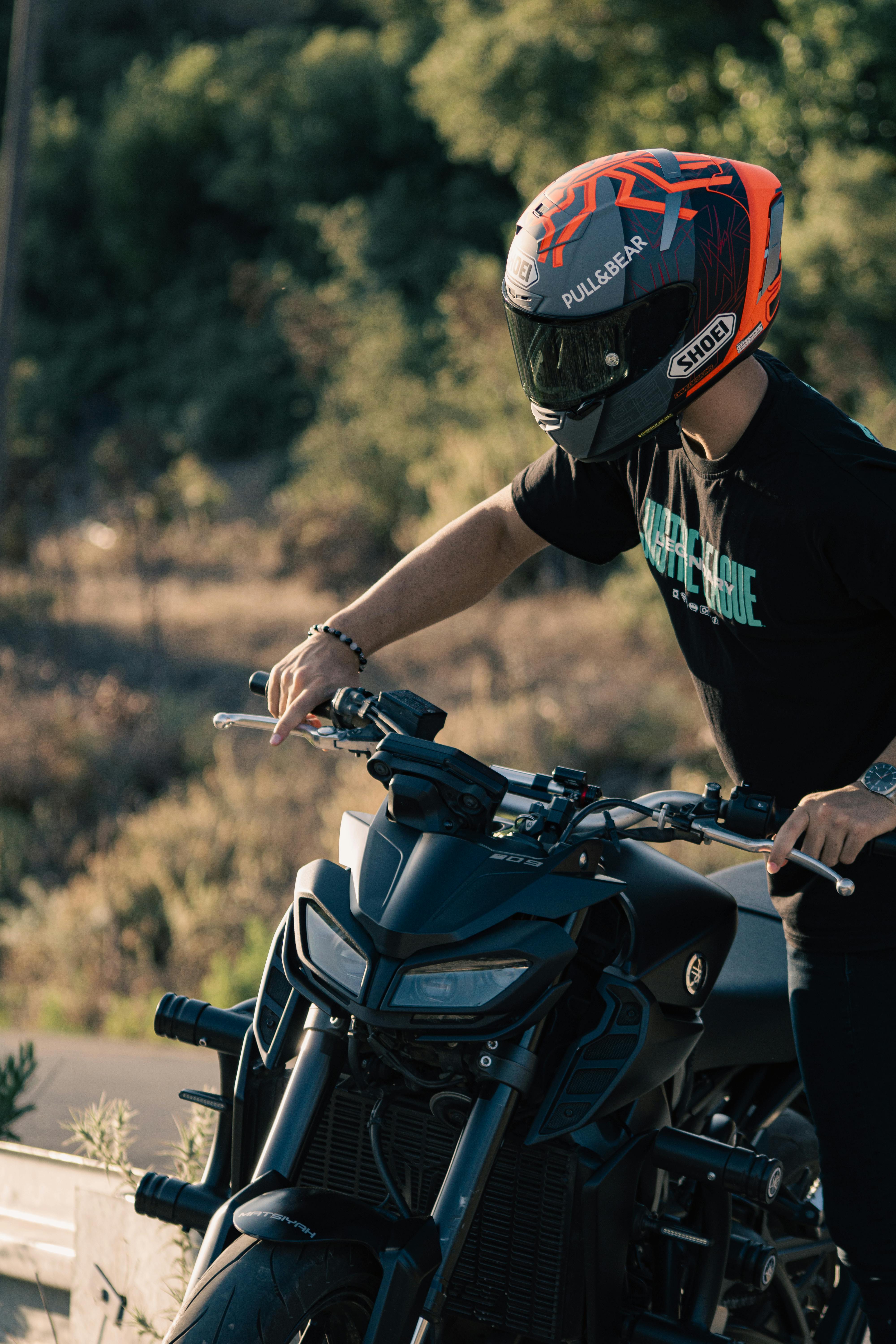 Man Wearing Helmet Riding a Motorbike Free Stock Photo