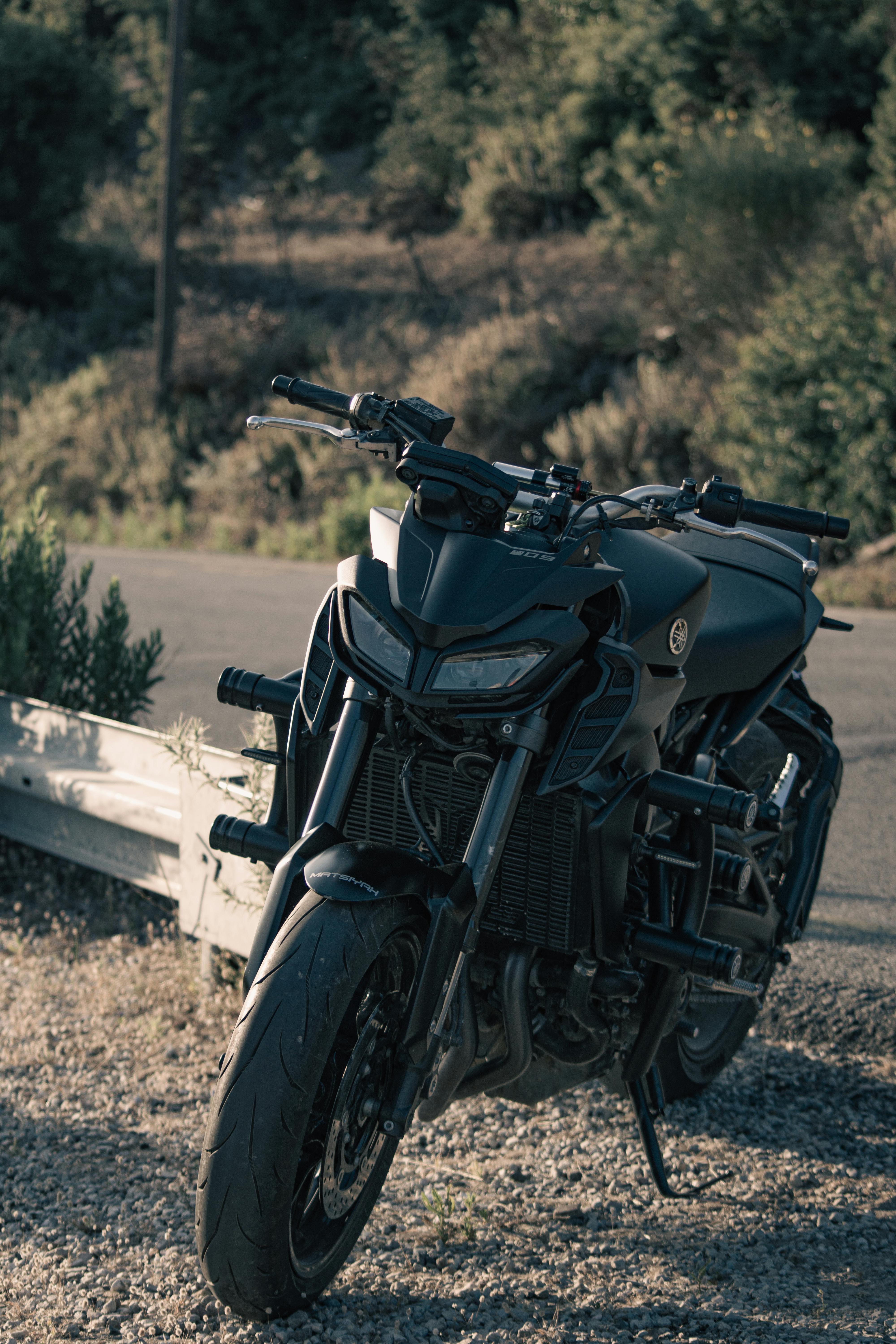 free photo of a black yamaha mt motorcycle parked on the side of the road