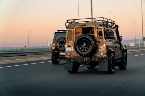 Land Rover Defenders on the Street at Sunset