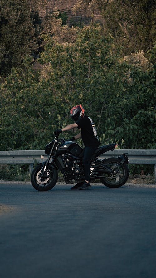Man Riding on a Black Yamaha MT Motorcycle 