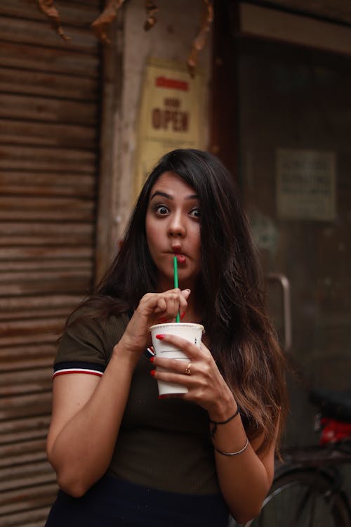 Woman Holding White Cup