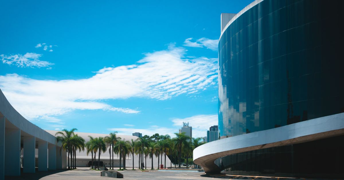 Exterior of Loveworld Arena building off Glory Gas Road in Ho Ghana with blue sky and palm trees