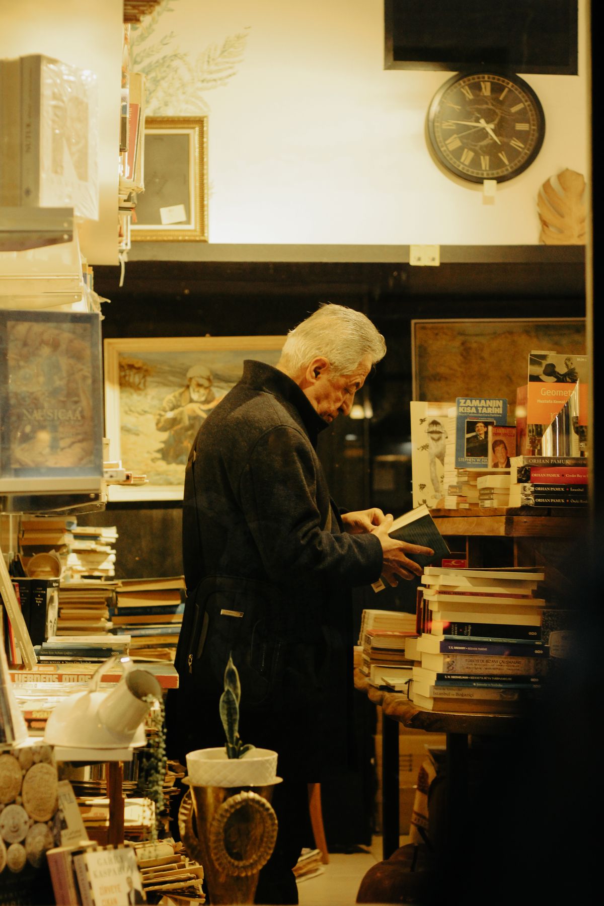 A collector examining books in a second-hand bookshop