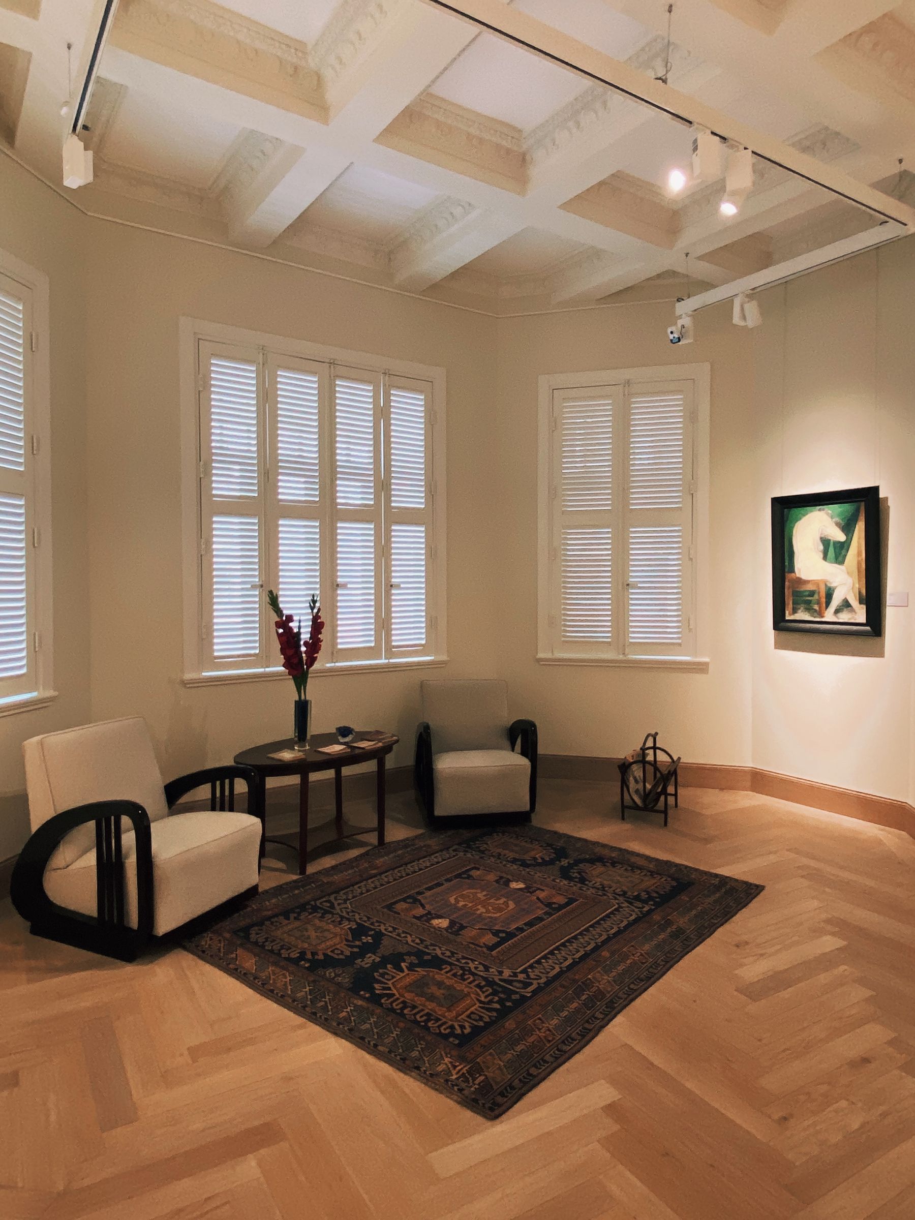 Warm living room combining patterned rug, upholstered seating and soft textiles