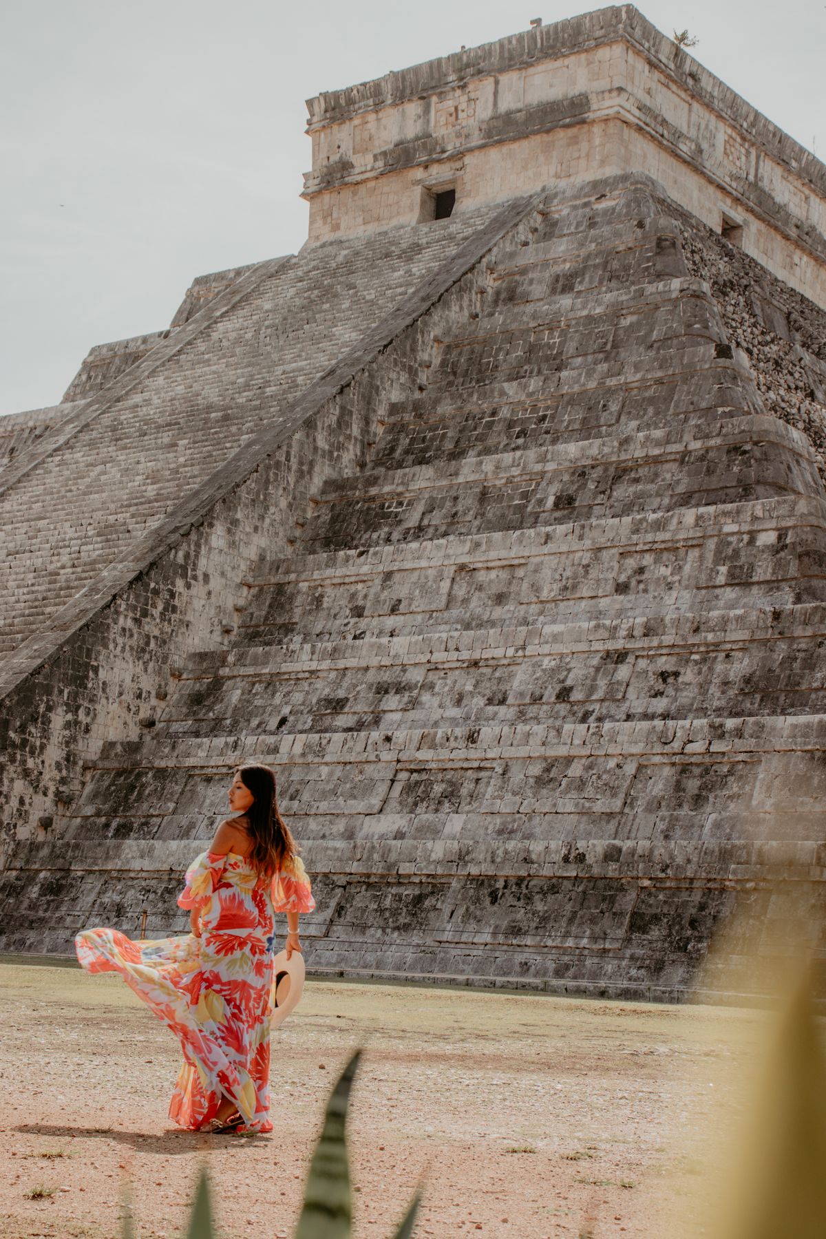 A woman in a sundress at a sunlit destination, tropical print made for beautiful places