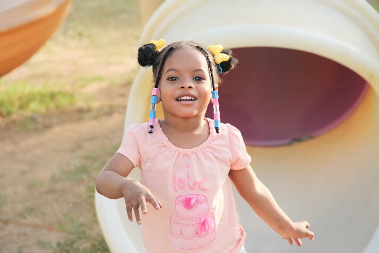 Smile Girl Against Slide Tube