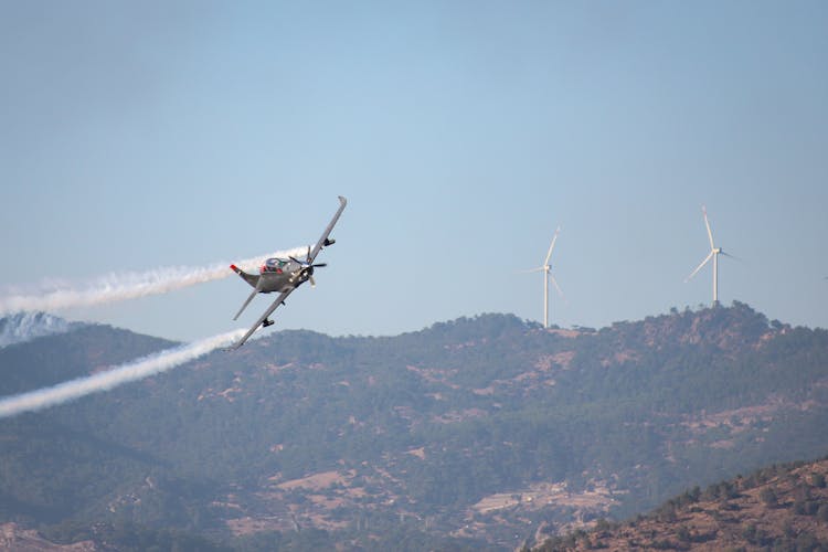 Small Airplane Flying Over Mountains