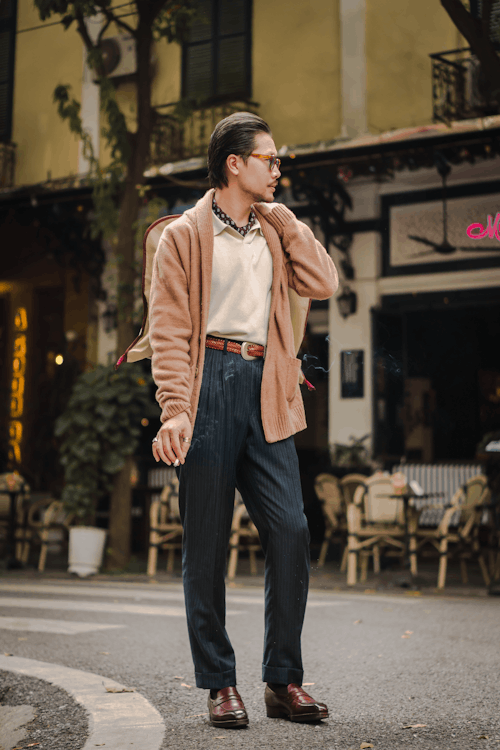 Man in Brown Cardigan and Gray Pants Walking on a Street
