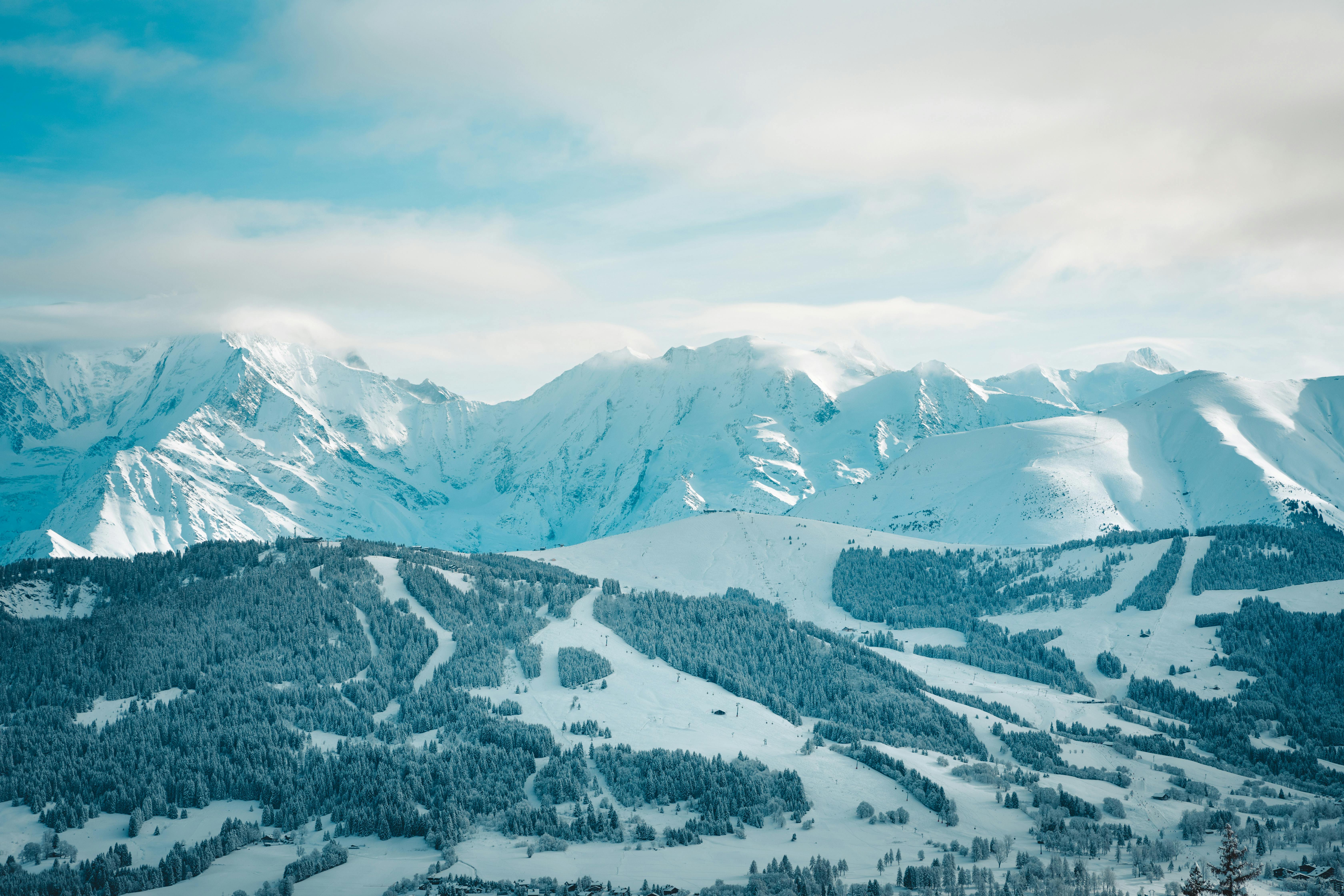 a view of a snowy mountain range with a ski slope