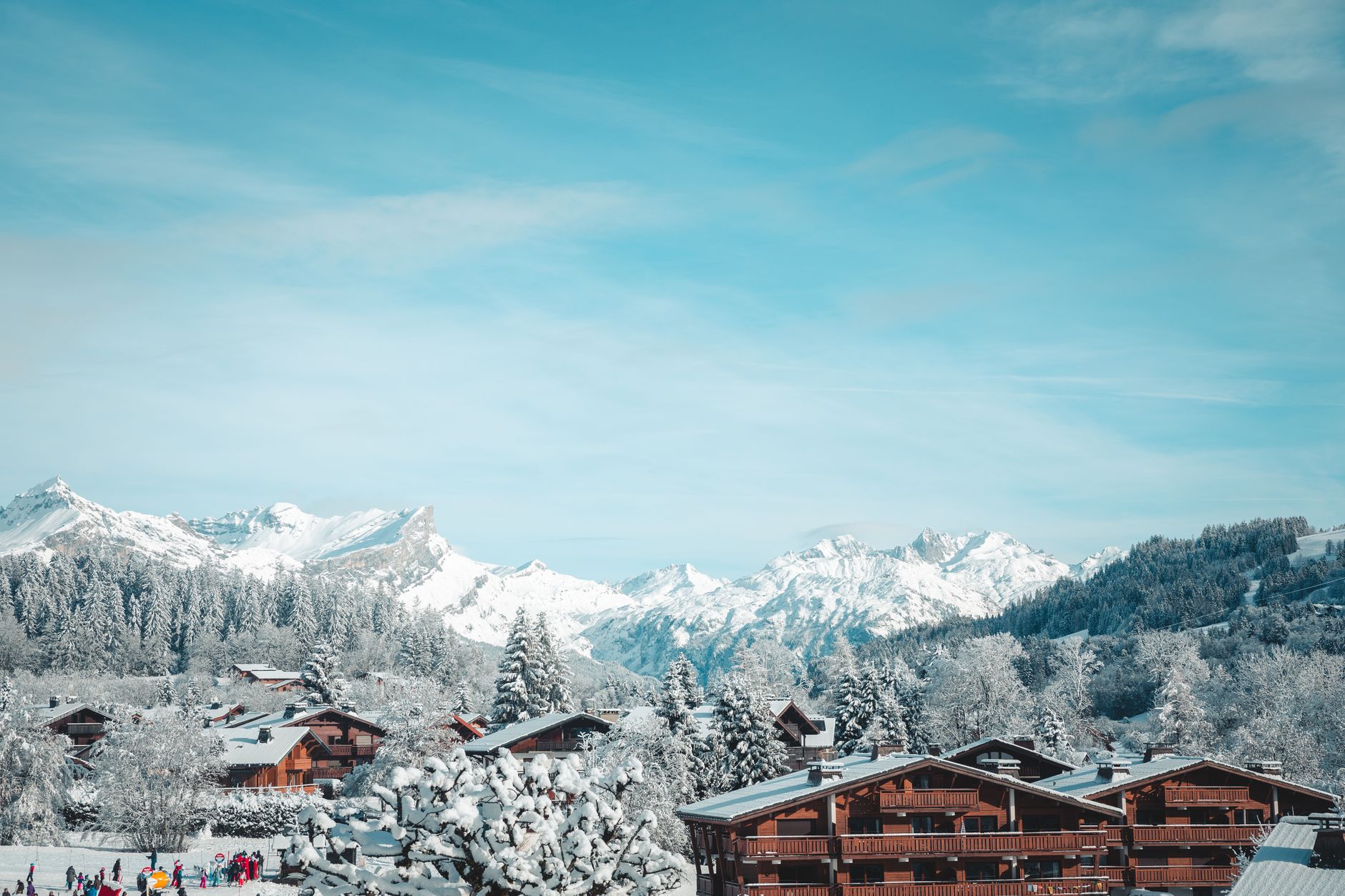 Snow-covered chalets in Megève with majestic mountain backdrop.