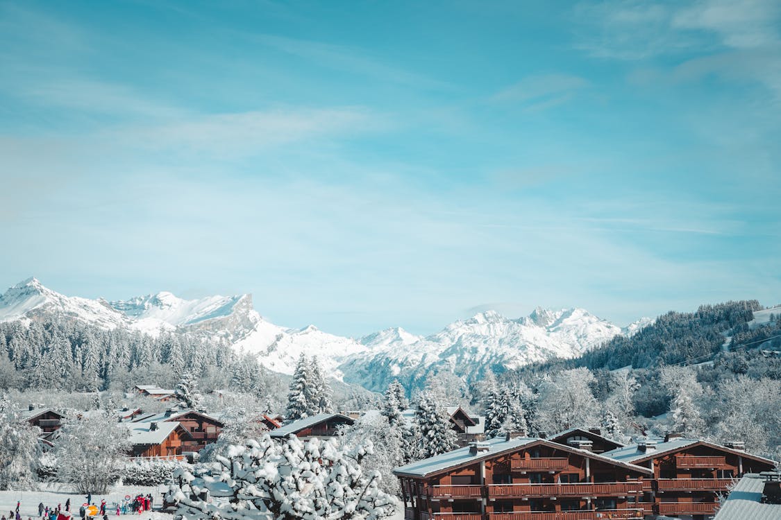 A snowy landscape with a mountain range and ski slopes