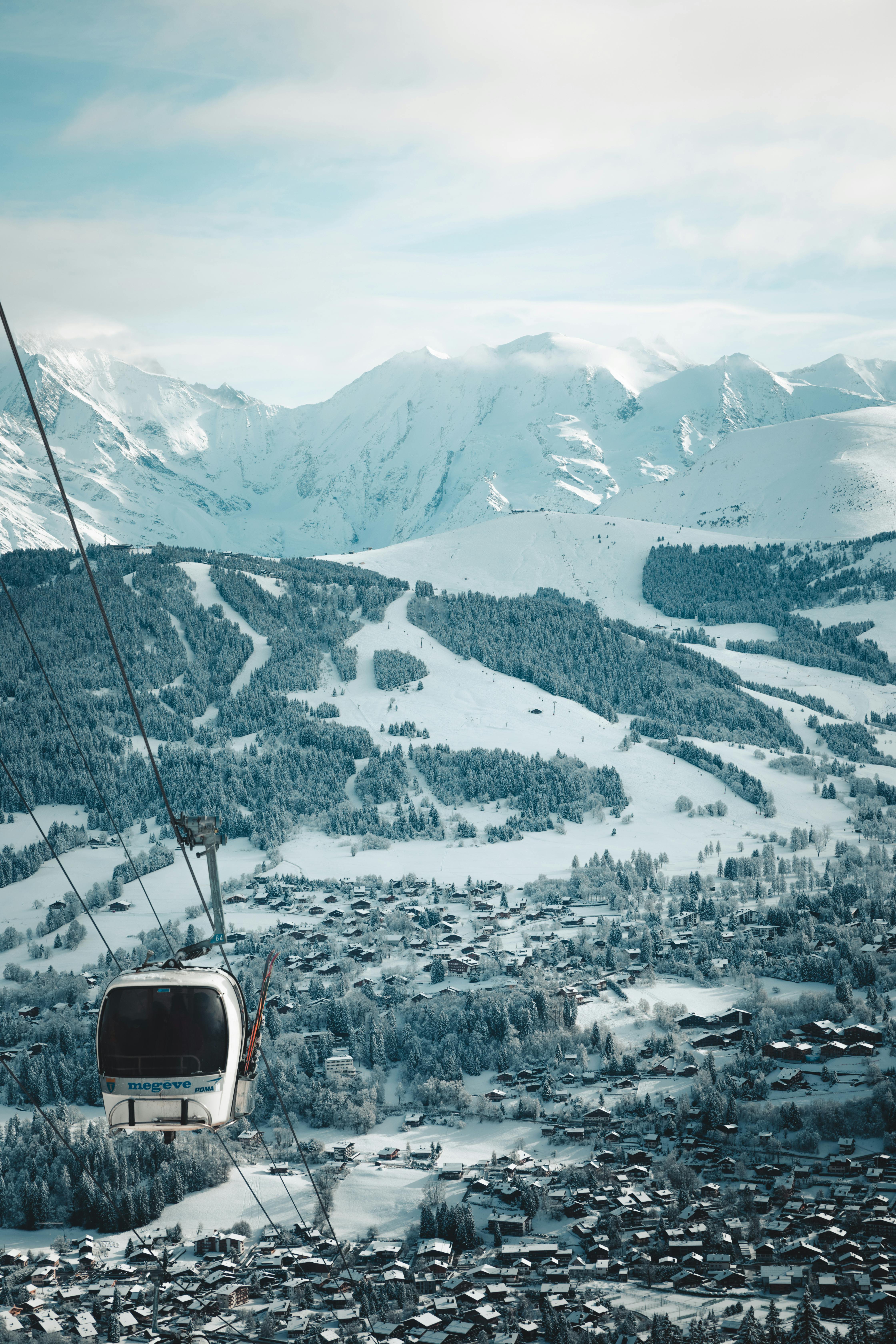 a cable car is seen in the snow covered mountains