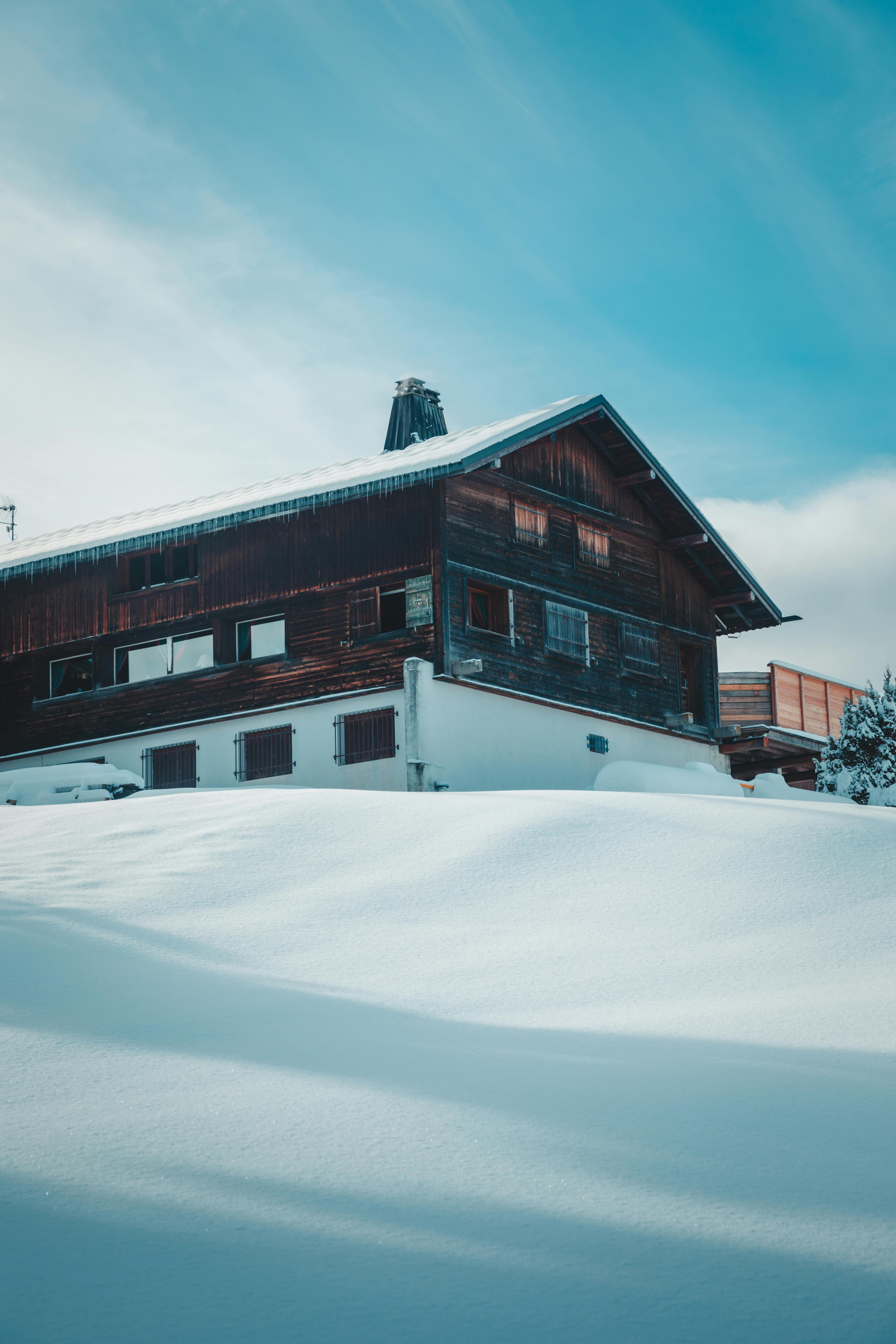 a house in the snow covered mountains