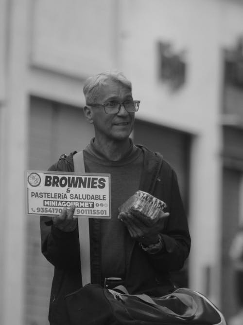 Man Advertising Sales of Brownies on the Street
