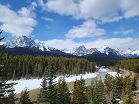 A stunning aerial view of snow-capped mountains and lush forests in Banff National Park.