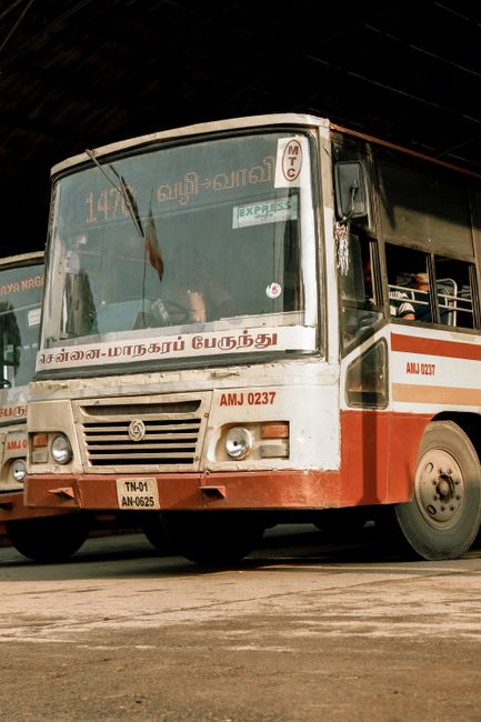 A classic Indian city bus with Tamil writing, showcasing local urban public transportation.