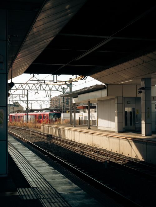 Free A serene view of an empty railway station platform in Toyokawa, Aichi, Japan, capturing urban architecture. Stock Photo
