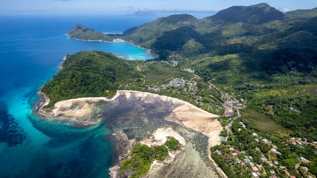 A breathtaking aerial view of Mahe Island's pristine coastline and lush landscapes in Seychelles. — lounges at Mahe Airport