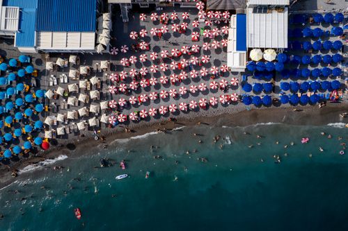 Free Stunning aerial shot of colorful beach umbrellas on the Amalfi Coast, Italy. Stock Photo
