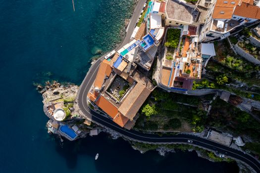 Drone shot of houses and roads along the Amalfi coast with stunning sea views.