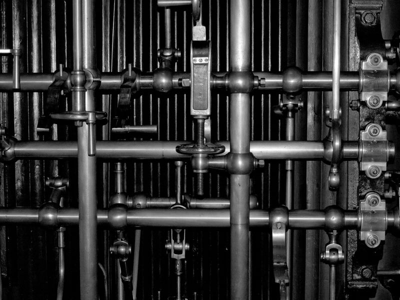 Industrial machinery pipes close-up in black and white