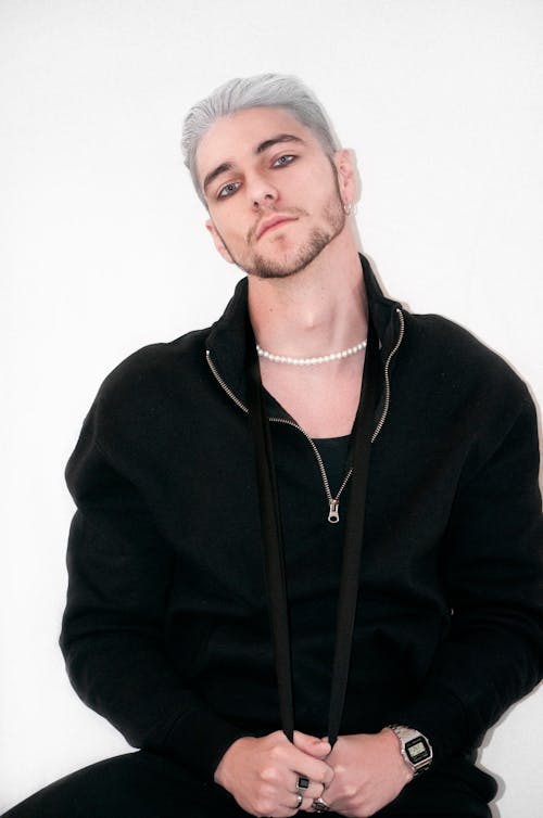 Man Dressed in Black Posing In a Studio