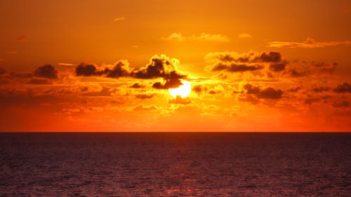 Free Vibrant sunset over the Atlantic Ocean in João Pessoa, Brazil with vivid orange skies and clouds. Stock Photo