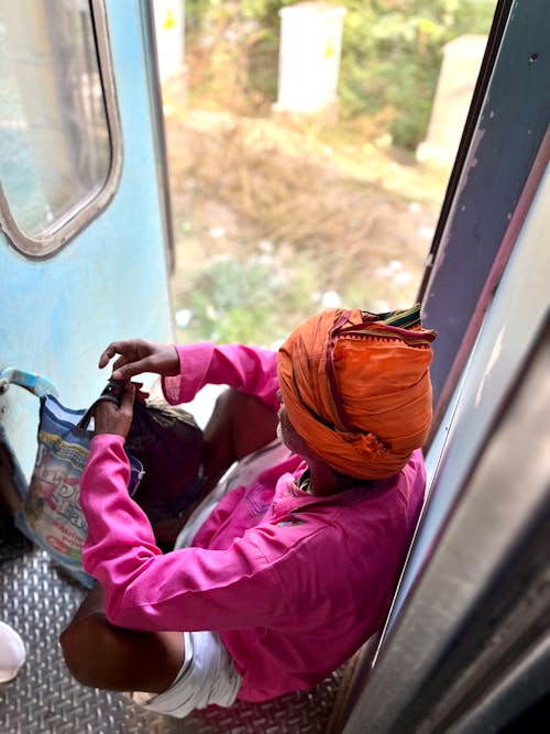 Man in Turban Sitting in Train Door